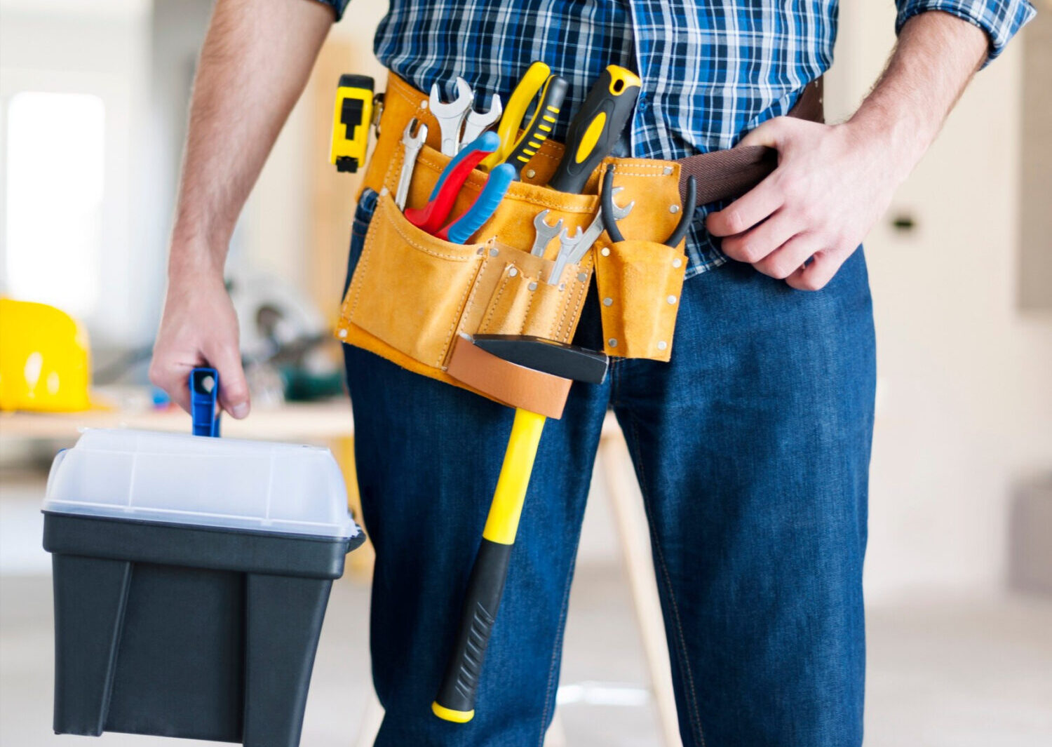 handyman-wearing-tool-belt Handyman wearing tool belt and carrying tool box.